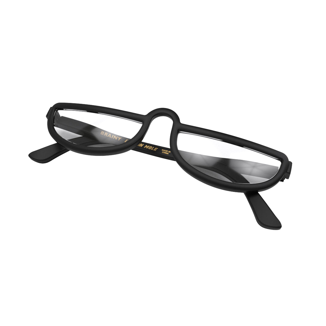 Closed skew - Brainy Reading Glasses in matt black featuring an oversized circular frame and provide crystal clear vision. Available in a + 1, 1.5, 2, 2.5, 3 prescriptions.