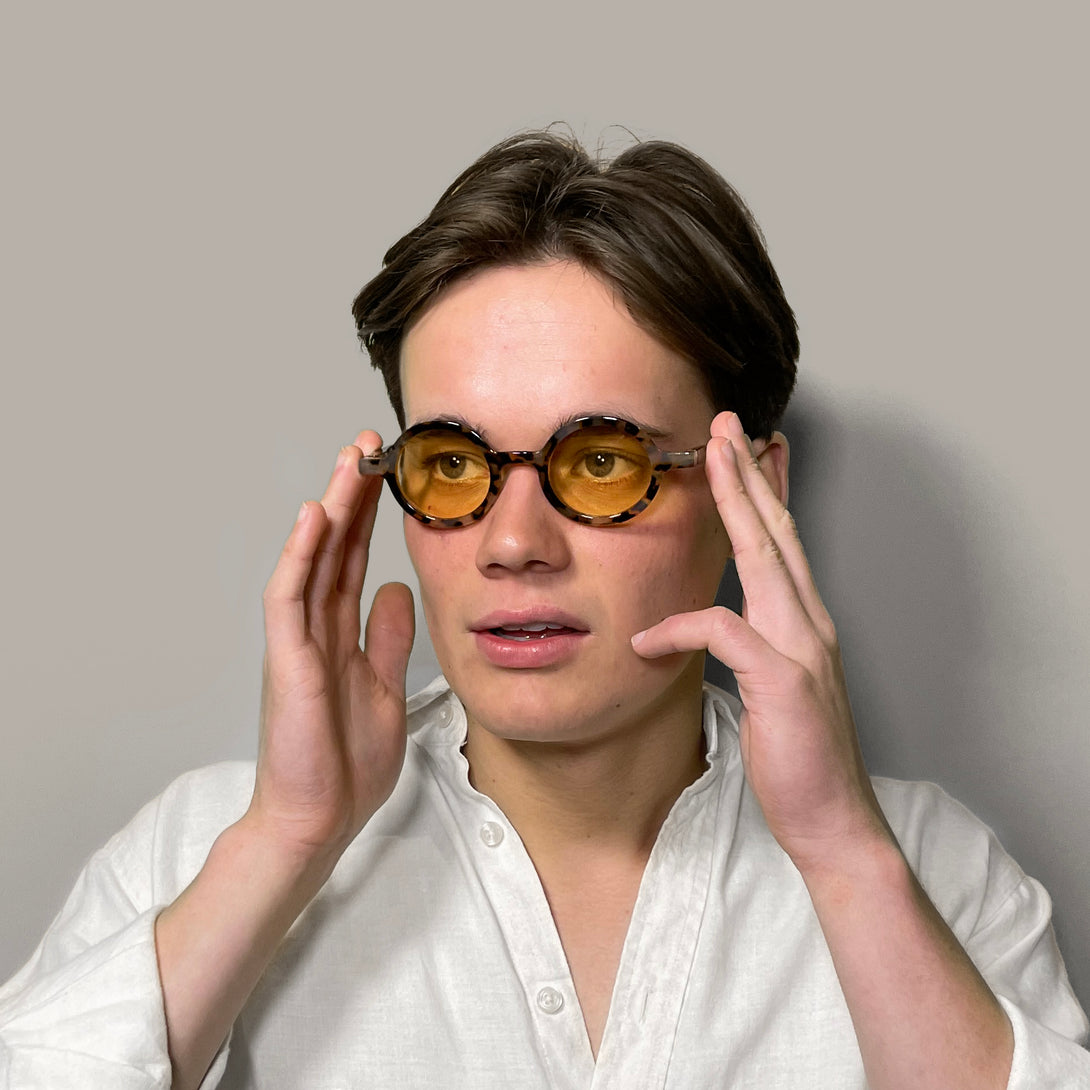 Male model - Moly sunglasses pale tortoiseshell featuring an eccentrically round frame and yellow UV400 lenses. The perfect accessory.