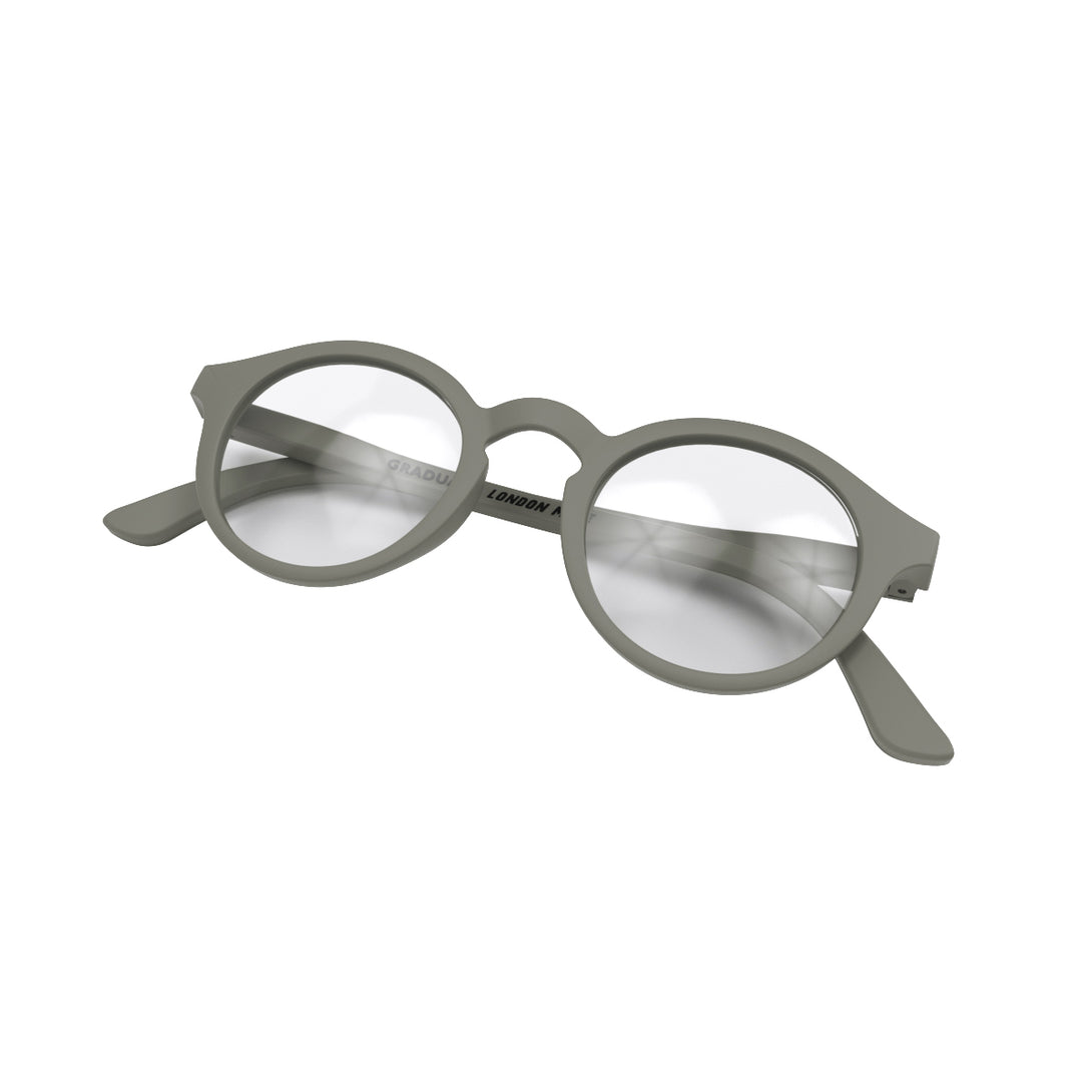 Folded skew - Graduate Reading Glasses in matt grey featuring a soft circle frame and provide crystal clear vision. Available in a + 1, 1.5, 2, 2.5, 3 prescriptions.