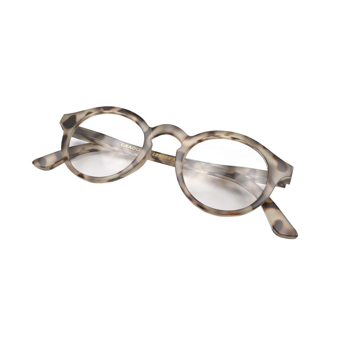 Folded skew - Graduate Reading Glasses in pale tortoiseshell featuring a soft circle frame and provide crystal clear vision. Available in a + 1, 1.5, 2, 2.5, 3 prescriptions.