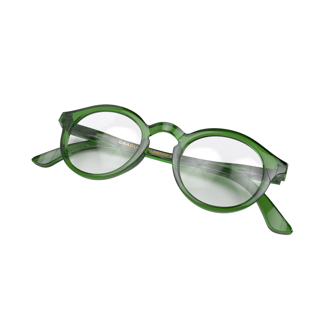 Folded skew - Graduate Blue Blocker Glasses in transparent green featuring a soft circle frame and the ability to protect your eyes from artificial blue light. Ideal for fashion accessories, screen time, office work, gaming, scrolling on a mobile, and watching TV. 