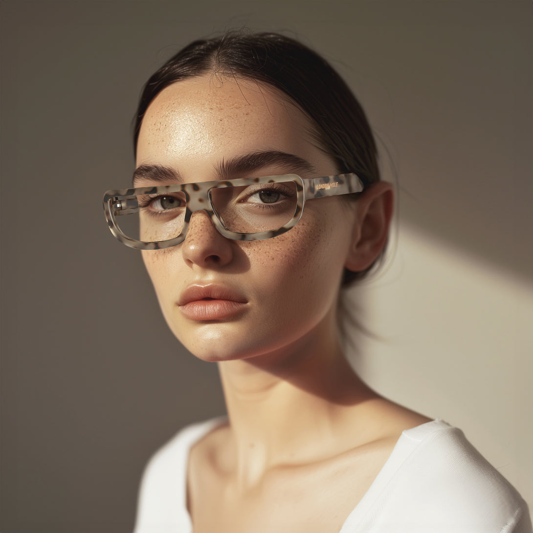 Female model - Feisty Reading Glasses in pale tortoiseshell featuring a utilitarian, striaght top line frame and provide crystal clear vision. Available in a + 1, 1.5, 2, 2.5, 3 prescriptions.