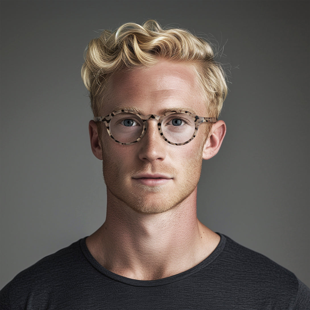 Male model - Graduate Reading Glasses in pale tortoiseshell featuring a soft circle frame and provide crystal clear vision. Available in a + 1, 1.5, 2, 2.5, 3 prescriptions.