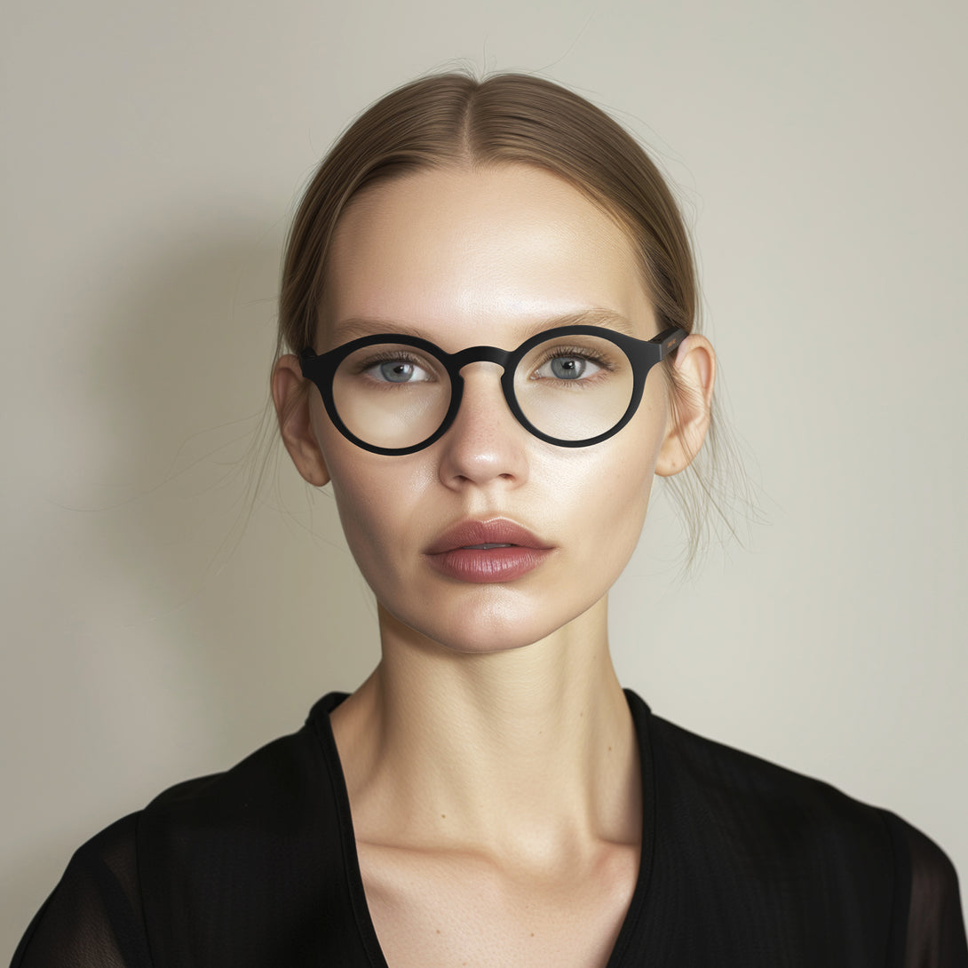 Female model - Graduate Blue Blocker Glasses in matt black featuring a soft circle frame and the ability to protect your eyes from artificial blue light. Ideal for fashion accessories, screen time, office work, gaming, scrolling on a mobile, and watching TV. 