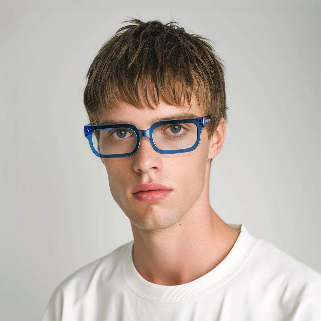 Male model - Icy Reading Glasses in transparent blue featuring a bold rectangle frame and provide crystal clear vision. Available in a + 1, 1.5, 2, 2.5, 3 prescriptions.