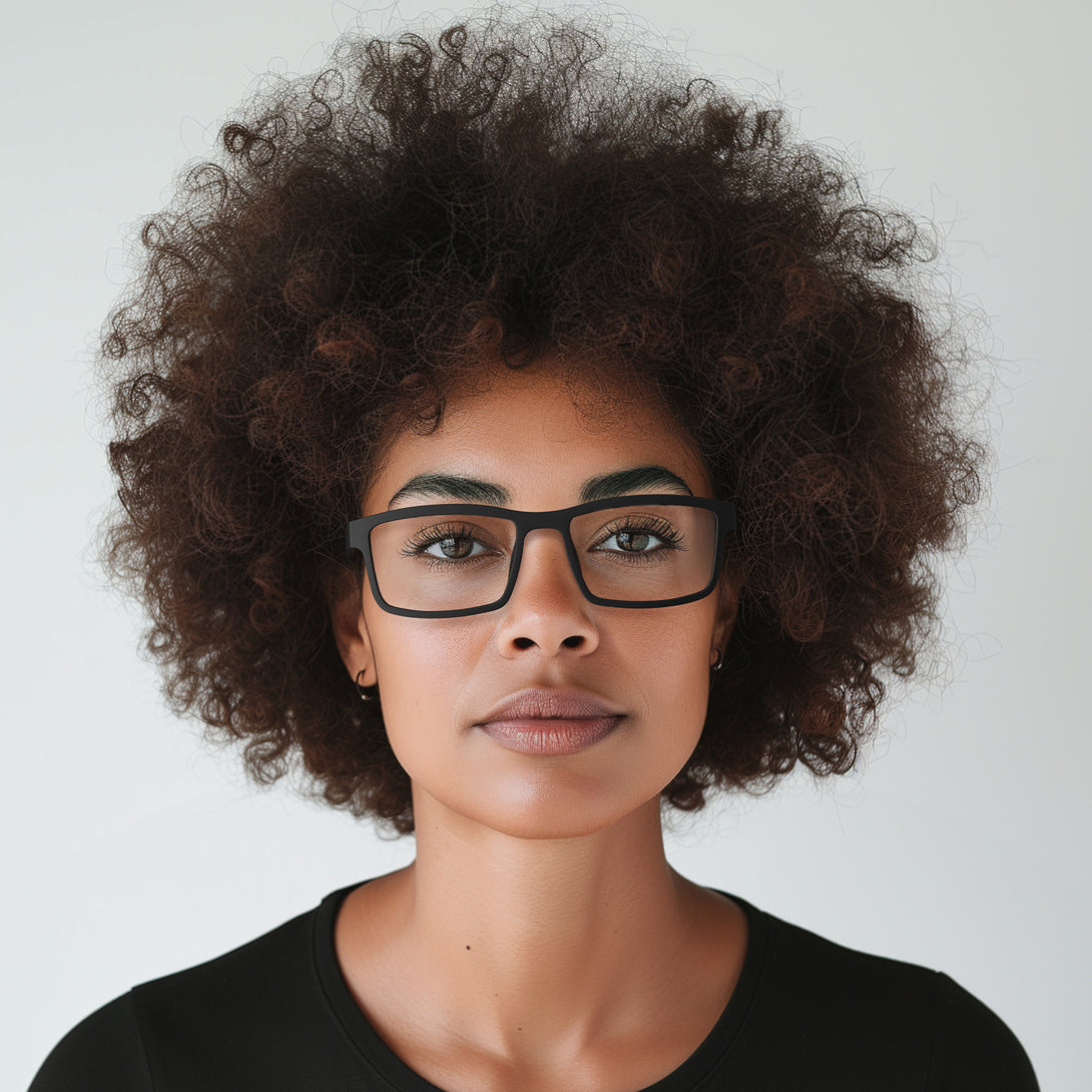 Female model - Inventor Reading Glasses in matt black featuring a classic rectangle frame made out of recycled materials and provide crystal clear vision. Available in a + 1, 1.5, 2, 2.5, 3 prescriptions.