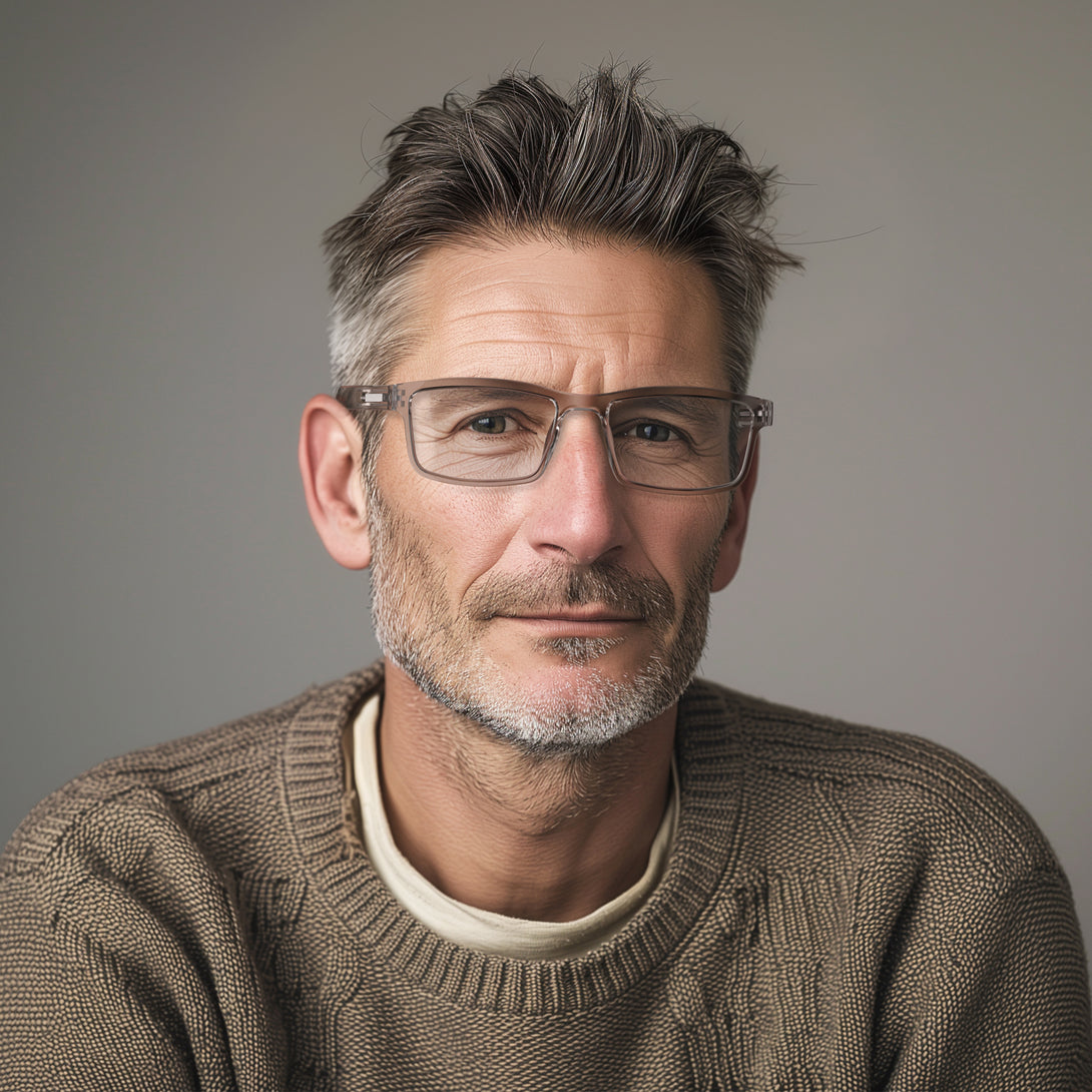 Male model - Inventor Reading Glasses in transparent grey featuring a classic rectangle frame made out of recycled materials and provide crystal clear vision. Available in a + 1, 1.5, 2, 2.5, 3 prescriptions.