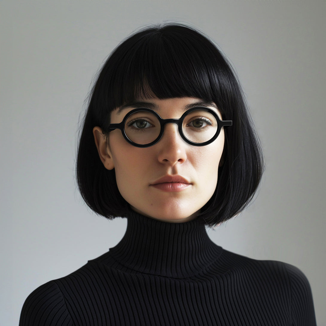 Female model - Moley Reading Glasses in gloss black featuring an eccentrically round frame and provide crystal clear vision. Available in a + 1, 1.5, 2, 2.5, 3 prescriptions.