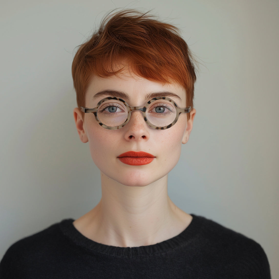 Female model - Moley Blue Blocker Glasses in gloss tortoiseshell featuring an eccentrically round frame and the ability to protect your eyes from artificial blue light. Ideal for fashion accessories, screen time, office work, gaming, scrolling on a mobile, and watching TV. 