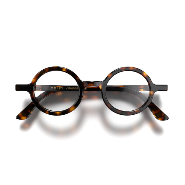 Front - Moley Blue Blocker Glasses in gloss tortoisehsell featuring an eccentrically round frame and the ability to protect your eyes from artificial blue light. Ideal for fashion accessories, screen time, office work, gaming, scrolling on a mobile, and watching TV. 