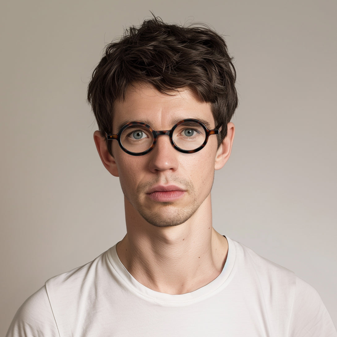 Male model - Moley Blue Blocker Glasses in gloss tortoisehsell featuring an eccentrically round frame and the ability to protect your eyes from artificial blue light. Ideal for fashion accessories, screen time, office work, gaming, scrolling on a mobile, and watching TV. 