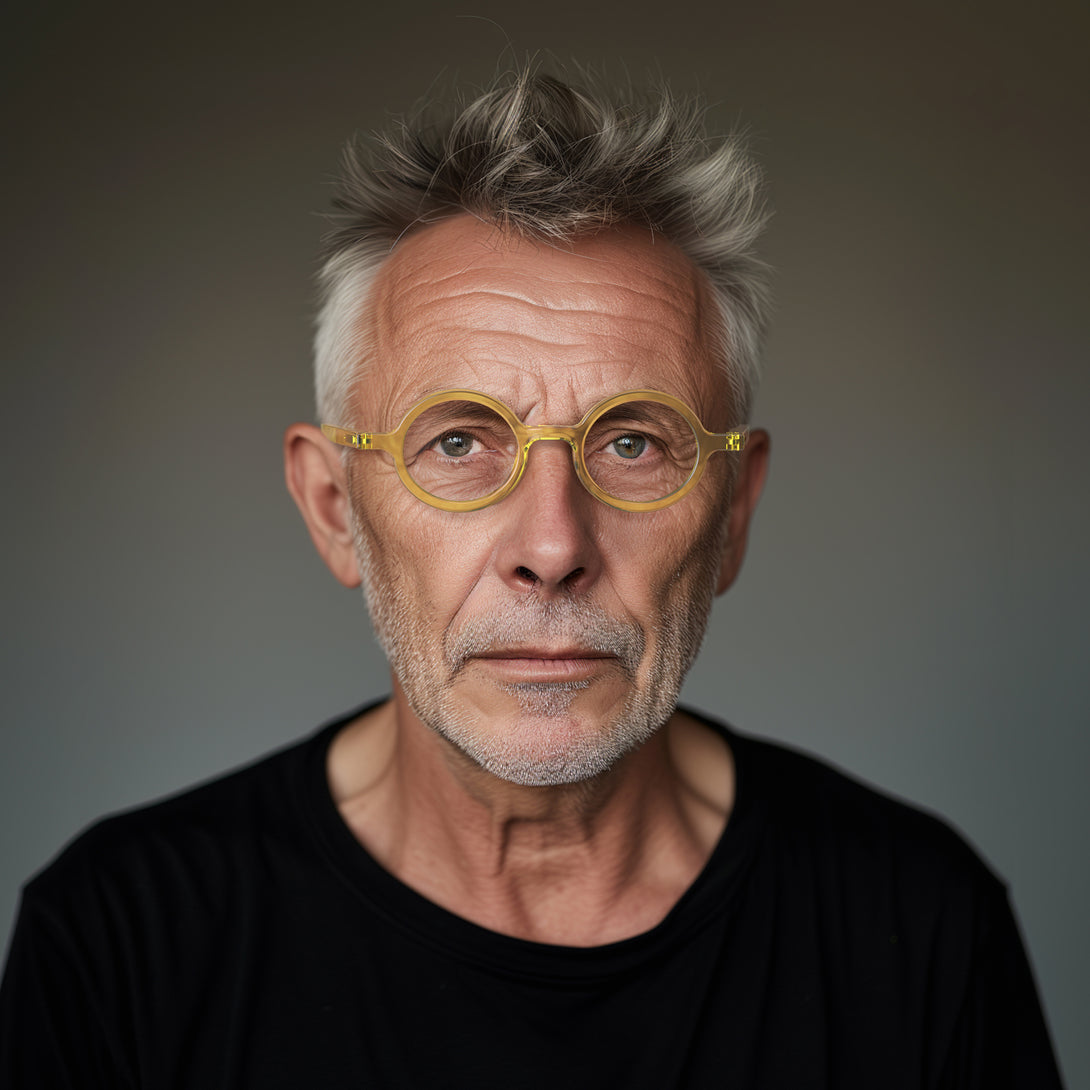 Male model - Moley Reading Glasses in transparent yellow featuring an eccentrically round frame and provide crystal clear vision. Available in a + 1, 1.5, 2, 2.5, 3 prescriptions.
