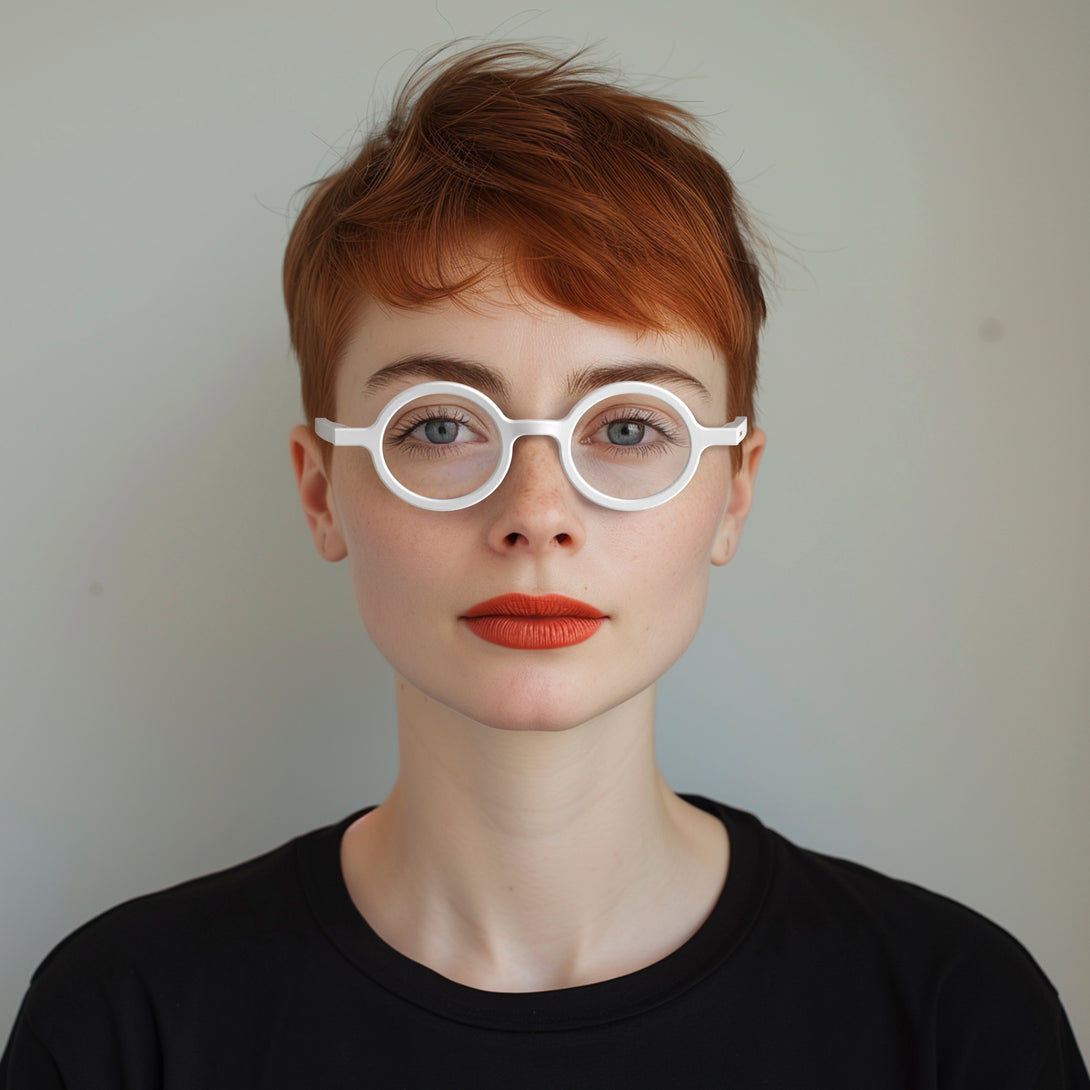 Female model - Moley Reading Glasses in matt white featuring an eccentrically round frame and provide crystal clear vision. Available in a + 1, 1.5, 2, 2.5, 3 prescriptions.