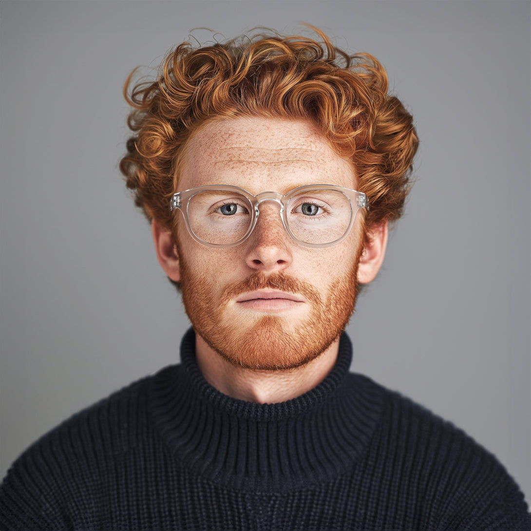 Male model - Monalux Blue Blocker Glasses featuring a the classic Oxford, rounded, transparent frame and the ability to protect your eyes from artificial blue light. Ideal for fashion accessories, screen time, office work, gaming, scrolling on a mobile, and watching TV. 