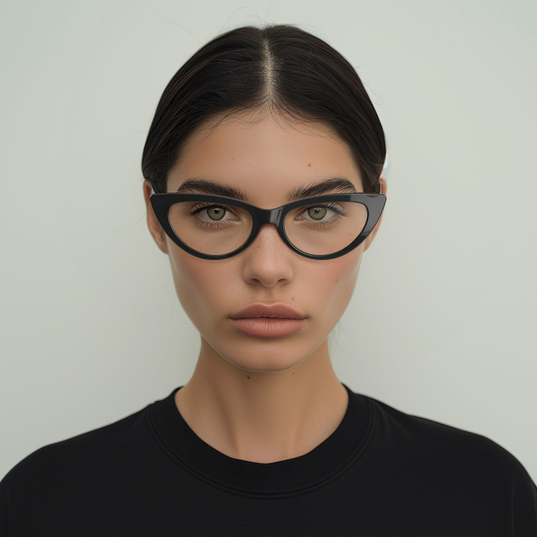 Female model  - Naughty Blue Blocker Glasses in gloss black featuring a classic cat-eye frame and the ability to protect your eyes from artificial blue light. Ideal for fashion accessories, screen time, office work, gaming, scrolling on a mobile, and watching TV. 