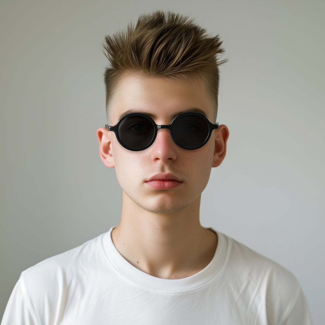 Male model - Artist sunglasses in gloss black featuring an oversized circular frame and black UV400 lenses. The finishing touch to every outfit while protecting your eyes. 