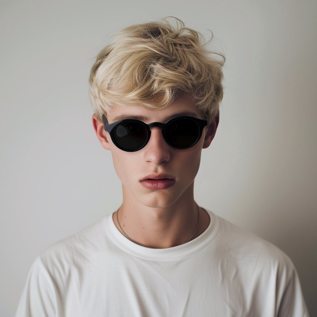 Male model - Graduate sunglasses in gloss black featuring a soft circle frame and black UV400 lenses. The finishing touch to every outfit while protecting your eyes. 