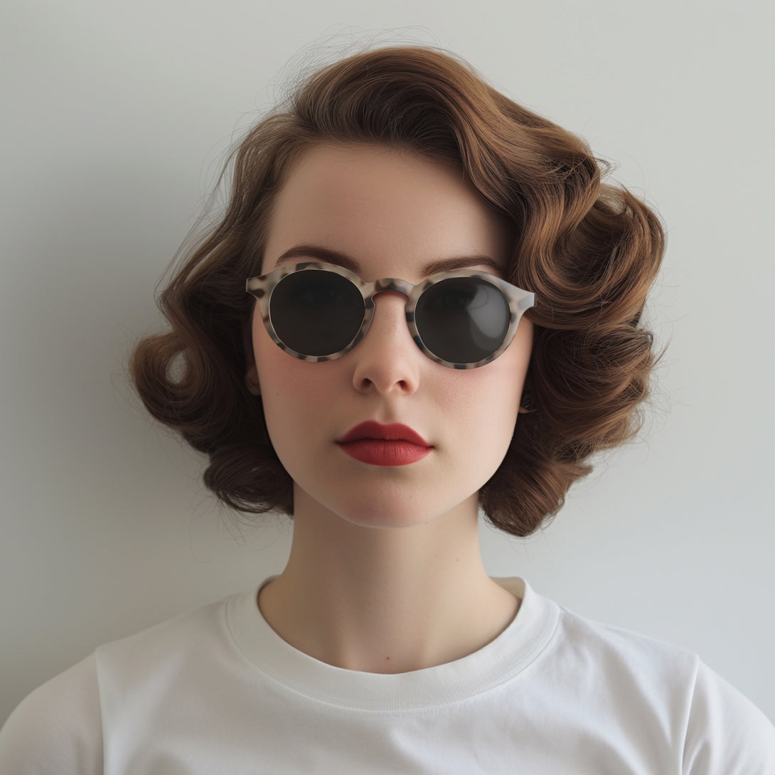 Female model - Graduate sunglasses in pale tortoiseshell featuring a soft circle frame and black UV400 lenses. The finishing touch to every outfit while protecting your eyes. 