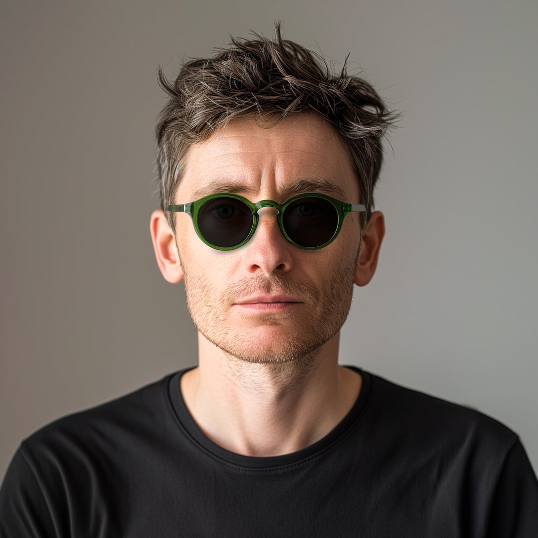 Male model - Graduate sunglasses in transparent green featuring a soft circle frame and black UV400 lenses. The finishing touch to every outfit while protecting your eyes. 