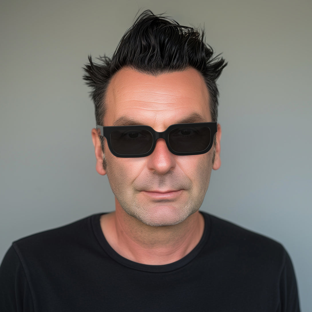 Male model - Icy sunglasses in gloss black featuring a bold rectangle frame and black UV400 lenses. The finishing touch to every outfit while protecting your eyes. 