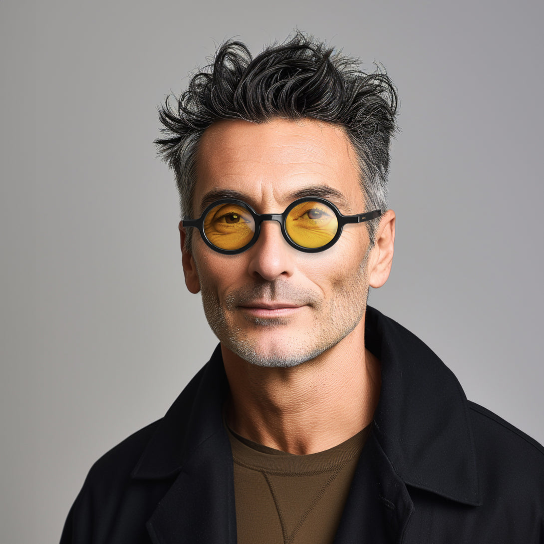 Male model - Moly sunglasses gloss black  featuring an eccentrically round frame and yellow UV400 lenses. The perfect accessory.