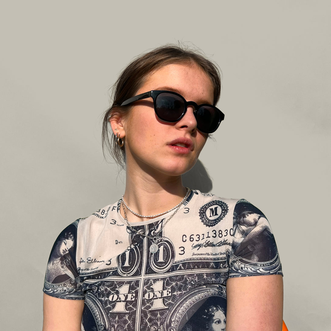 Female model - Monalux sunglasses in gloss black featuring a the classic Oxford, rounded frame and black UV400 lenses. The perfect accessory.