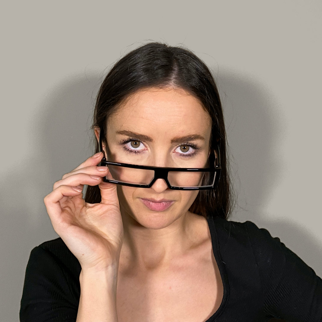 Female model - Spacey Reading Glasses in matt black featuring a modern rectangle frame with a utilitarian look and providing crystal clear vision. Available in a + 1, 1.5, 2, 2.5, 3 prescriptions.