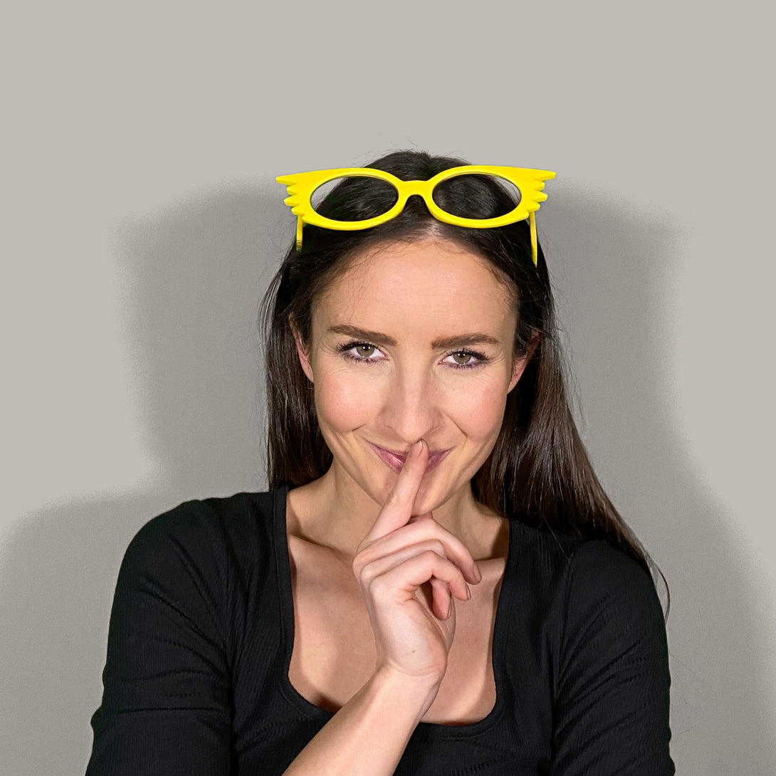 Female model -  Speedy Blue Blocker Glasses in matt yellow featuring an extravagent vintage frame with a utilitarian look and the ability to protect your eyes from artificial blue light. Ideal for fashion accessories, screen time, office work, gaming, scrolling on a mobile, and watching TV. 