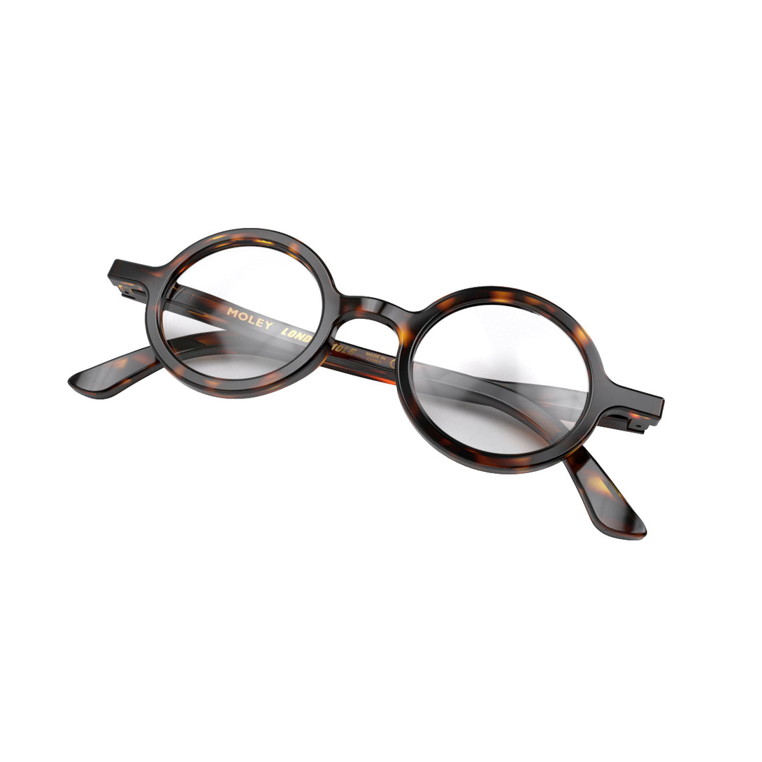 Folded skew - Moley Reading Glasses in tortoisehsell featuring an eccentrically round frame and provide crystal clear vision. Available in a + 1, 1.5, 2, 2.5, 3 prescriptions.