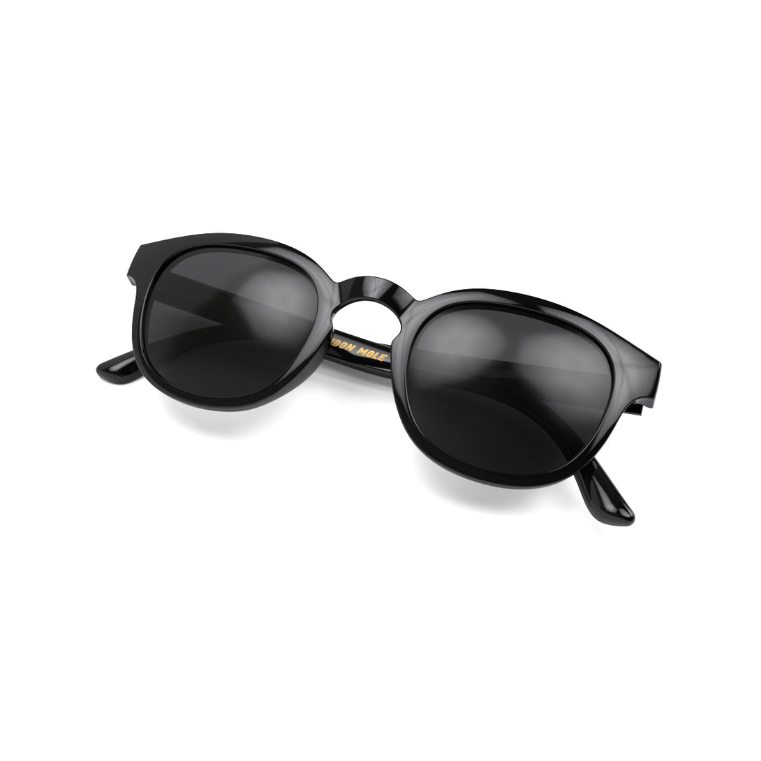Open skew - Monalux sunglasses in gloss black featuring a the classic Oxford, rounded frame and black UV400 lenses. The perfect accessory.
