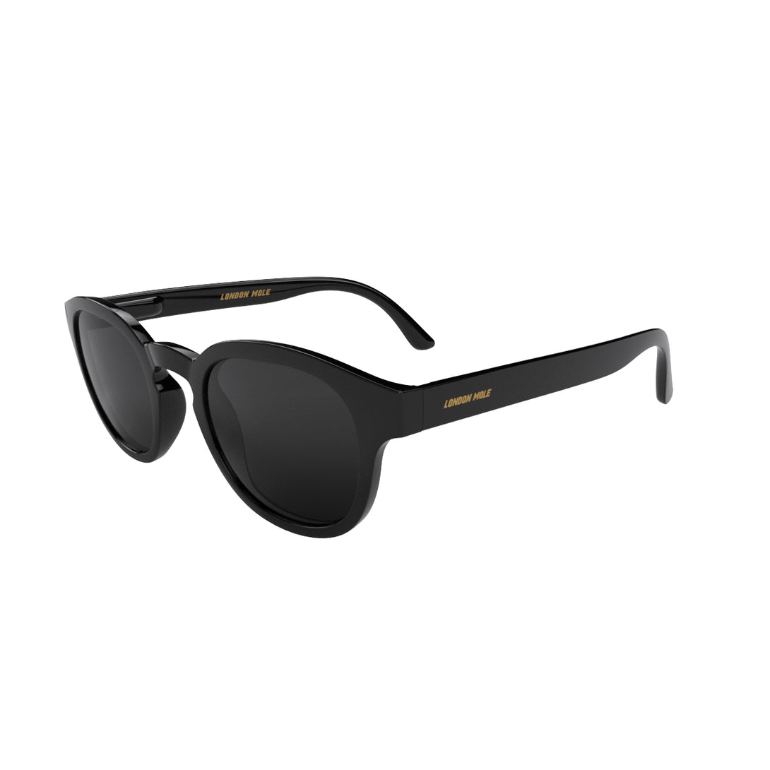 Open skew - Monalux sunglasses in gloss black featuring a the classic Oxford, rounded frame and black UV400 lenses. The perfect accessory.