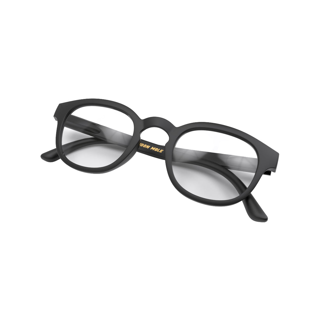 Folded skew - Monalux Blue Blocker Glasses in matt black featuring a the classic Oxford, rounded frame and the ability to protect your eyes from artificial blue light. Ideal for fashion accessories, screen time, office work, gaming, scrolling on a mobile, and watching TV. 