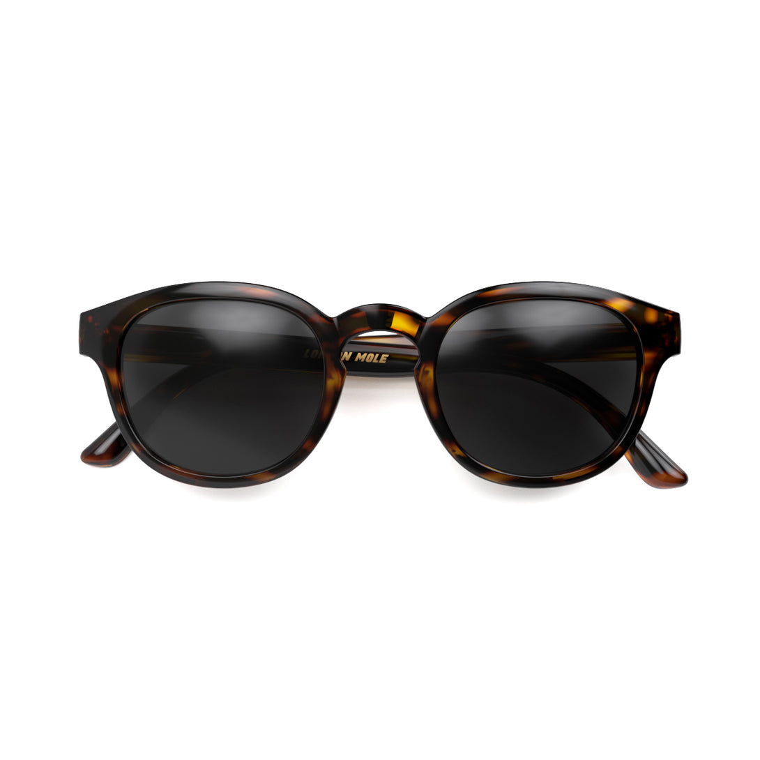 Front - Monalux sunglasses in gloss tortoiseshell featuring a the classic Oxford, rounded frame and black UV400 lenses. The perfect accessory.