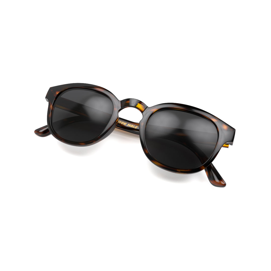 Folded skew - Monalux sunglasses in gloss tortoiseshell featuring a the classic Oxford, rounded frame and black UV400 lenses. The perfect accessory.