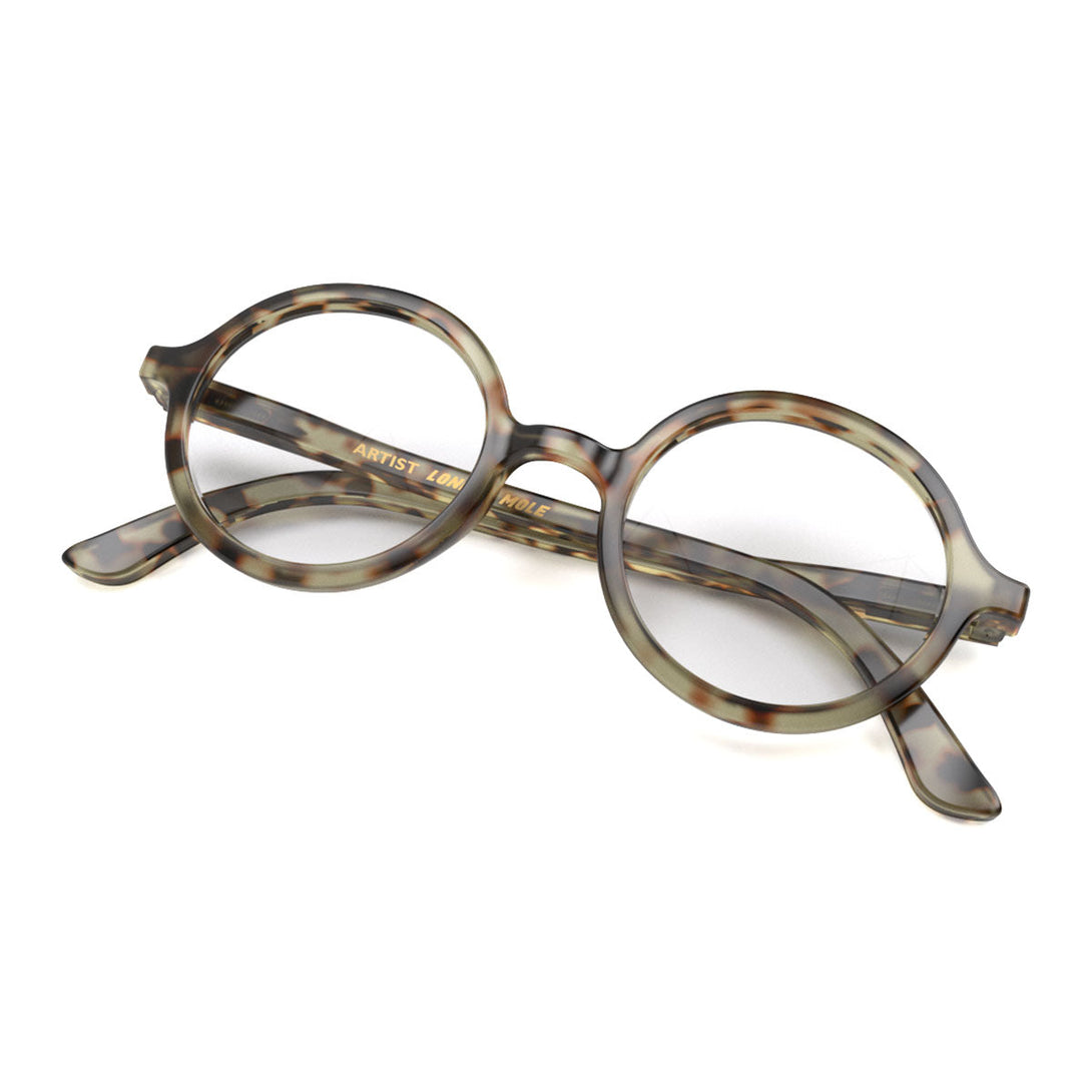 Skew - Artist Reading Glasses in pale tortoiseshell featuring an oversized circular frame and provide crystal clear vision. Available in a + 1, 1.5, 2, 2.5, 3 prescriptions.