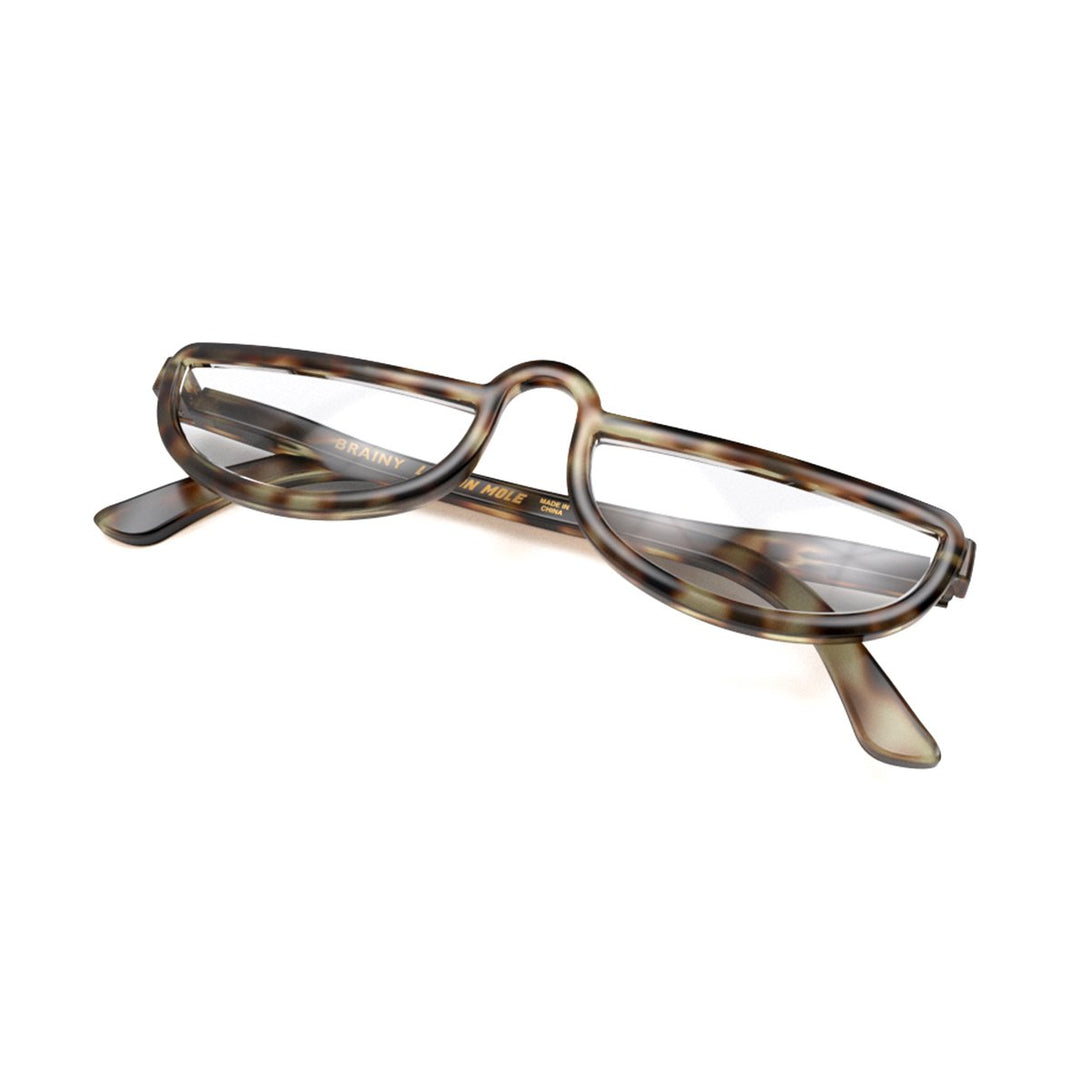 Closed skewed - Brainy Reading Glasses in pale tortoiseshell featuring an oversized circular frame and provide crystal clear vision. Available in a + 1, 1.5, 2, 2.5, 3 prescriptions.