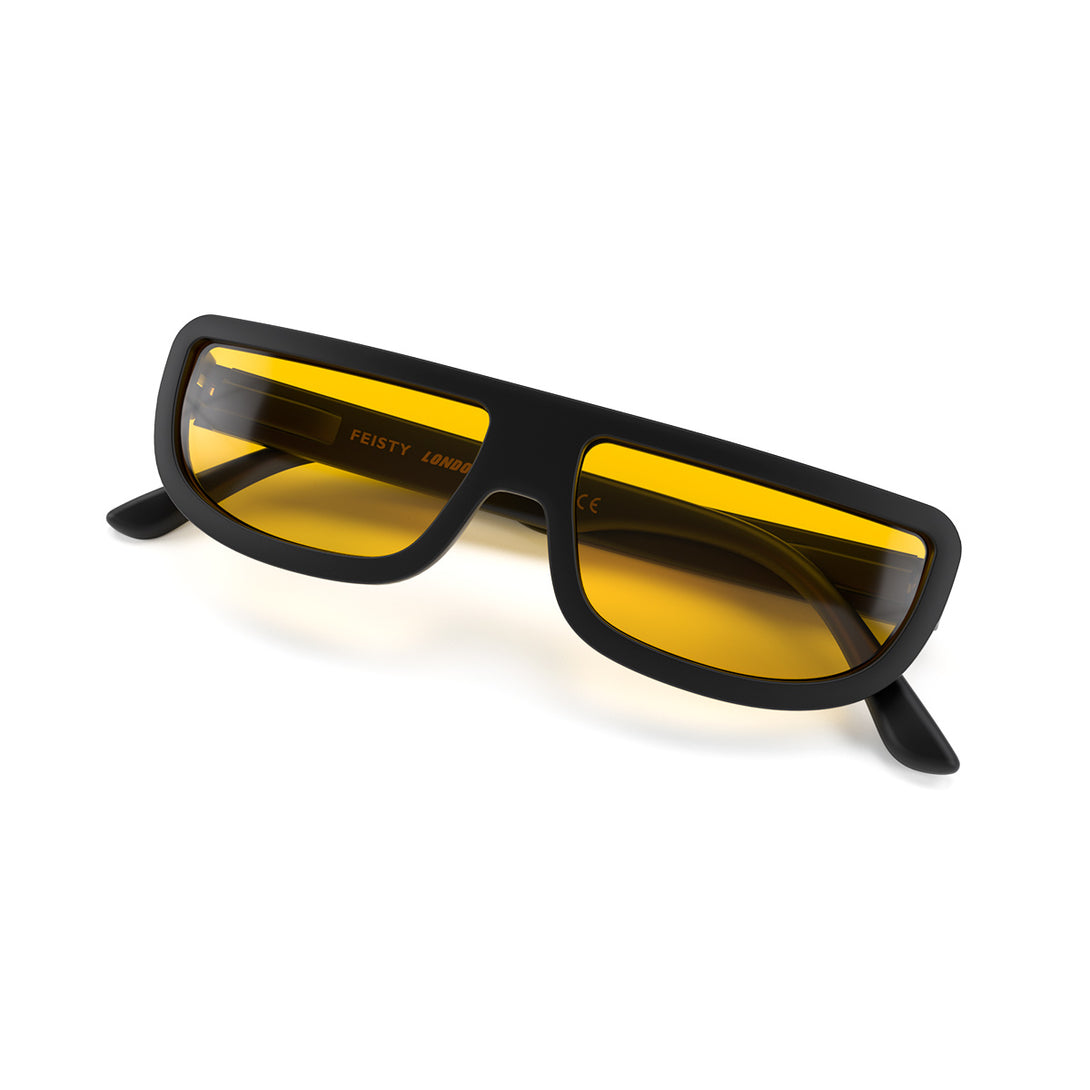 Folded skew - Feisty sunglasses in matt black featuring a utilitarian, straight top line frame and yellow UV400 lenses. The finishing touch to every outfit while protecting your eyes. 