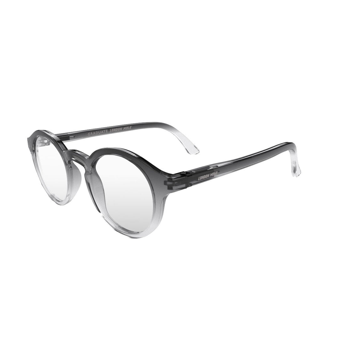 Open skew - Graduate Reading Glasses in black transparent fade featuring a soft circle frame and provide crystal clear vision. Available in a + 1, 1.5, 2, 2.5, 3 prescriptions.