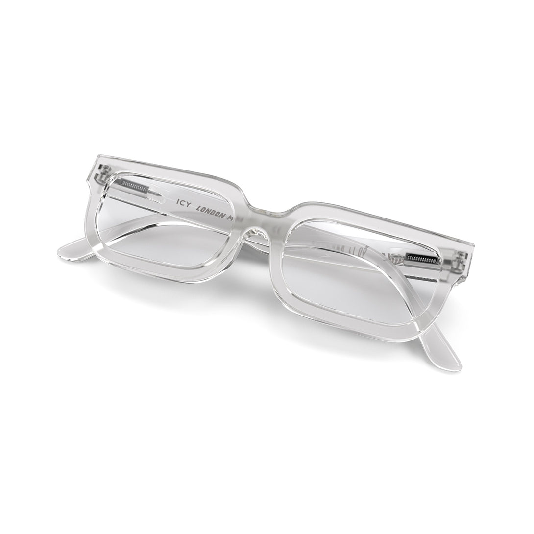 Folded skew - Icy Blue Blocker Glasses featuring a bold rectangle, transparent frame and the ability to protect your eyes from artificial blue light. Ideal for fashion accessories, screen time, office work, gaming, scrolling on a mobile, and watching TV. 