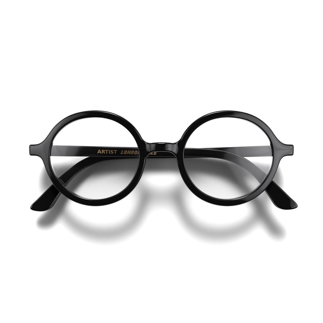 Front - Artist Reading Glasses in gloss black featuring an oversized circular frame and provide crystal clear vision. Available in a + 1, 1.5, 2, 2.5, 3 prescriptions.