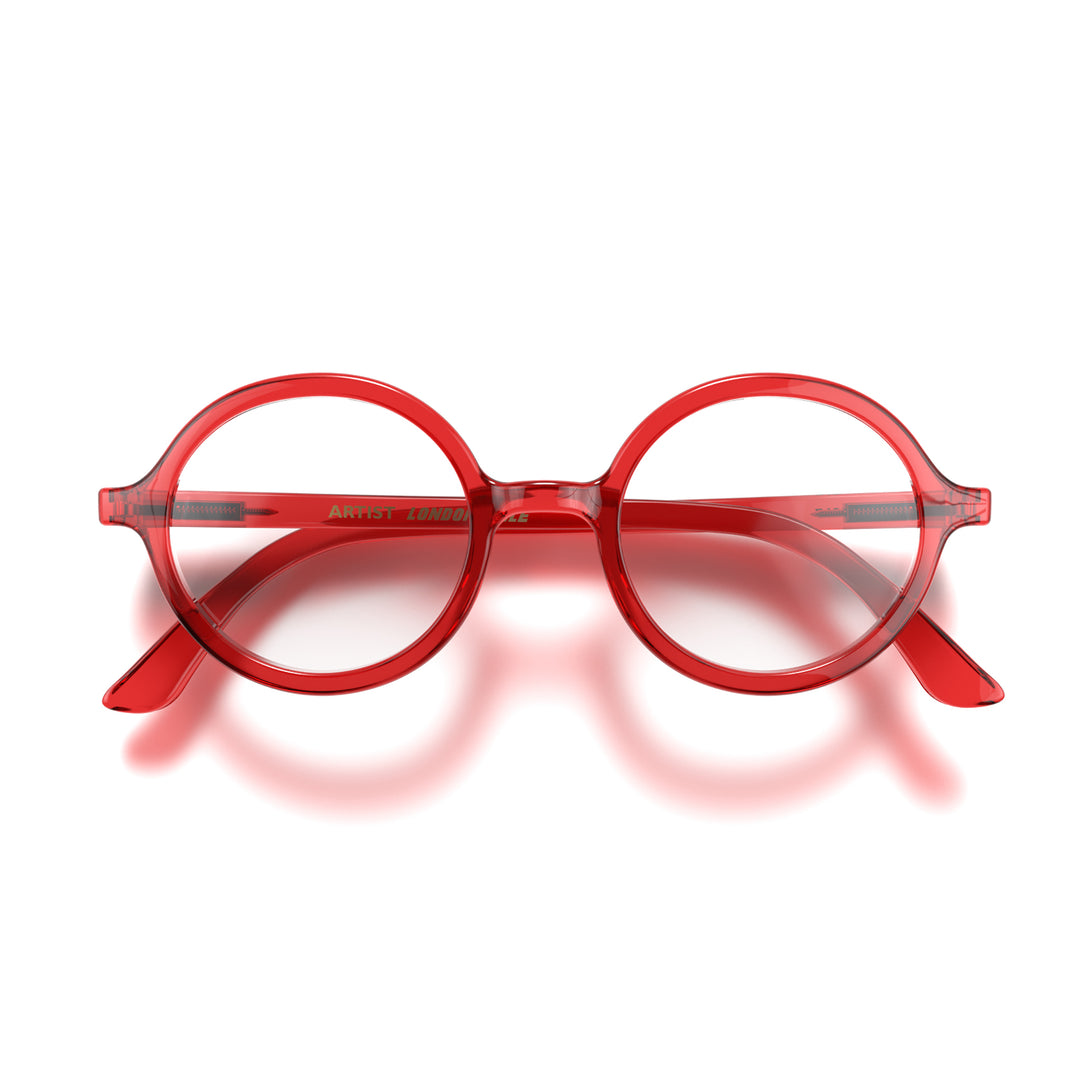Front - Artist Reading Glasses in transparent red featuring an oversized circular frame and provide crystal clear vision. Available in a + 1, 1.5, 2, 2.5, 3 prescriptions.