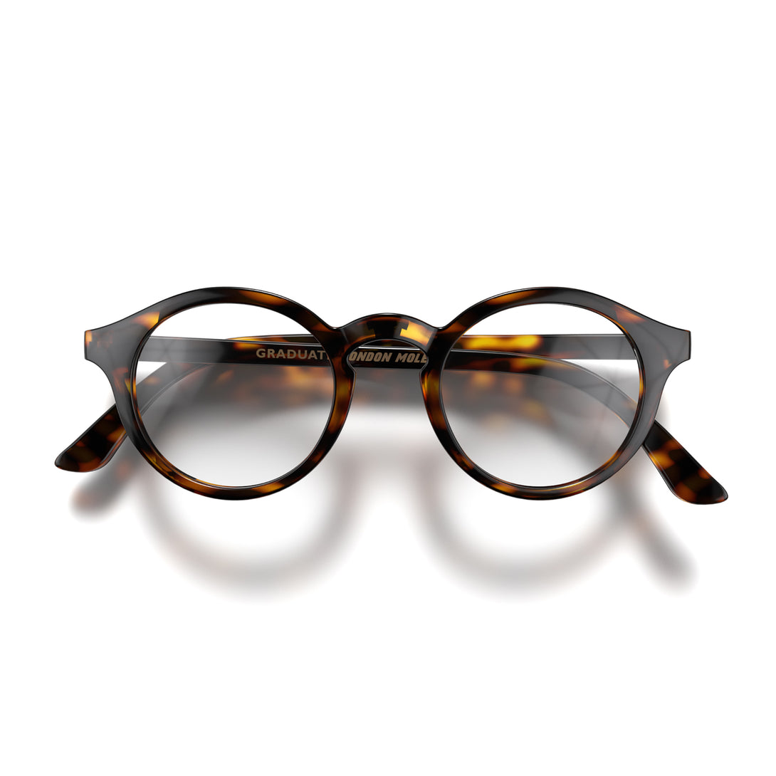 Front - Graduate Blue Blocker Glasses in brown tortoiseshell featuring a soft circle frame and the ability to protect your eyes from artificial blue light. Ideal for fashion accessories, screen time, office work, gaming, scrolling on a mobile, and watching TV. 