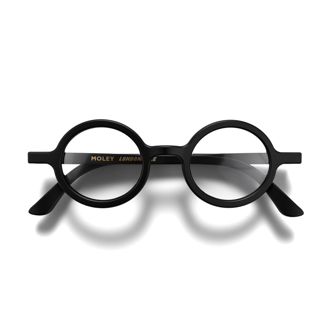Folded front - Moley Reading Glasses in matt black featuring an eccentrically round frame and provide crystal clear vision. Available in a + 1, 1.5, 2, 2.5, 3 prescriptions.