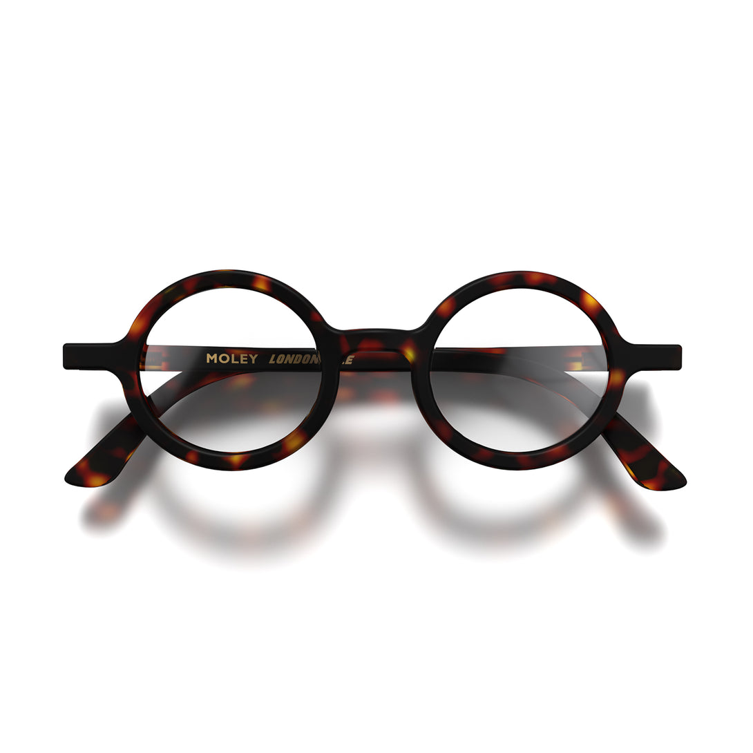 Front - Moley Reading Glasses in matt tortoiseshell featuring an eccentrically round frame and provide crystal clear vision. Available in a + 1, 1.5, 2, 2.5, 3 prescriptions.
