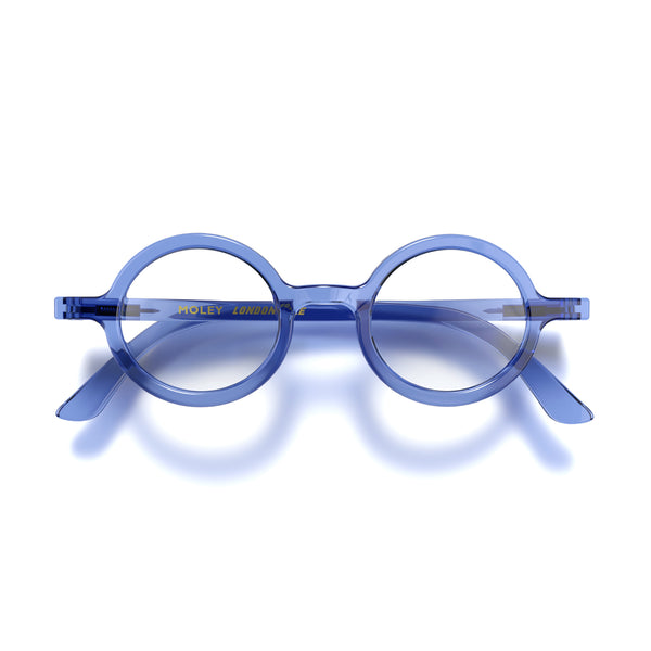 Front - Moley Blue Blocker Glasses in transparent blue featuring an eccentrically round frame and the ability to protect your eyes from artificial blue light. Ideal for fashion accessories, screen time, office work, gaming, scrolling on a mobile, and watching TV. 