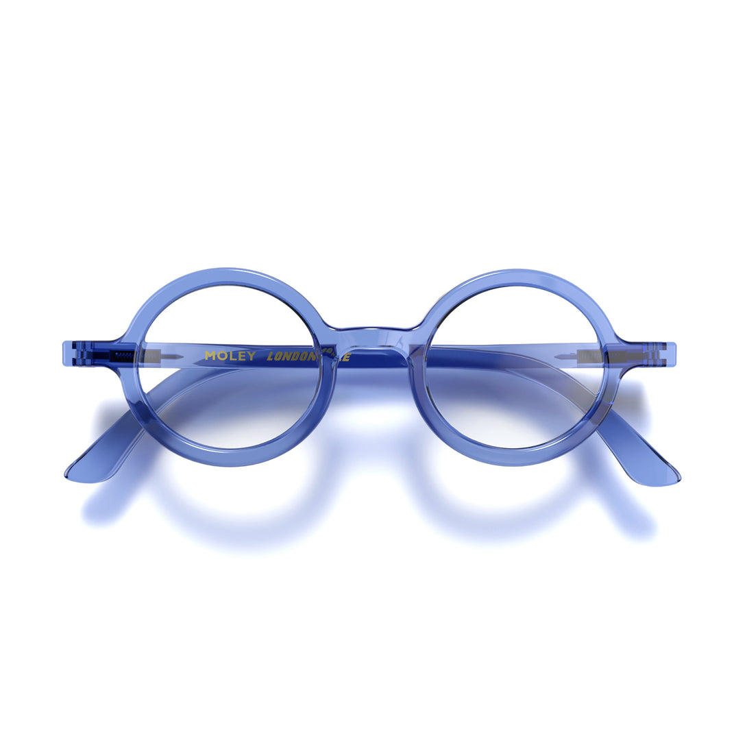 Front - Moley Reading Glasses in transparent blue featuring an eccentrically round frame and provide crystal clear vision. Available in a + 1, 1.5, 2, 2.5, 3 prescriptions.