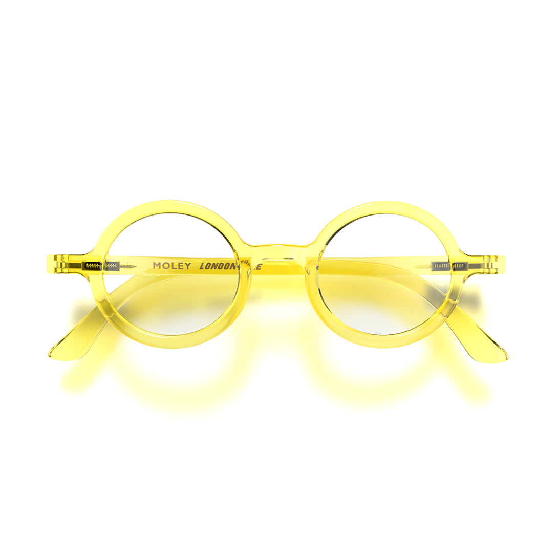 Front - Moley Blue Blocker Glasses in transparent yellow featuring an eccentrically round frame and the ability to protect your eyes from artificial blue light. Ideal for fashion accessories, screen time, office work, gaming, scrolling on a mobile, and watching TV. 