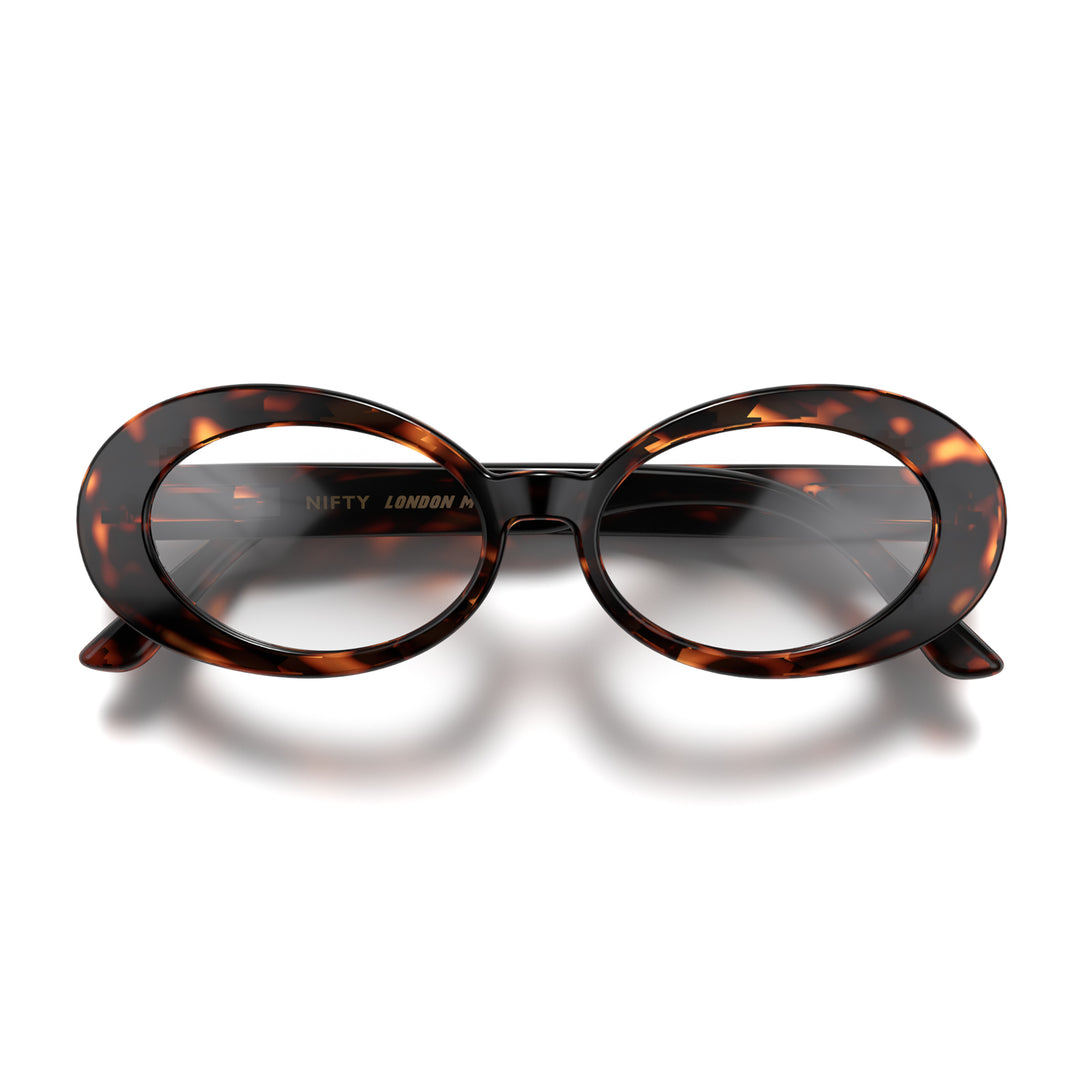 Front - Nifty Blue Blocker Glasses in tortoiseshell featuring a bold, vintage oval frame and the ability to protect your eyes from artificial blue light. Ideal for fashion accessories, screen time, office work, gaming, scrolling on a mobile, and watching TV. 