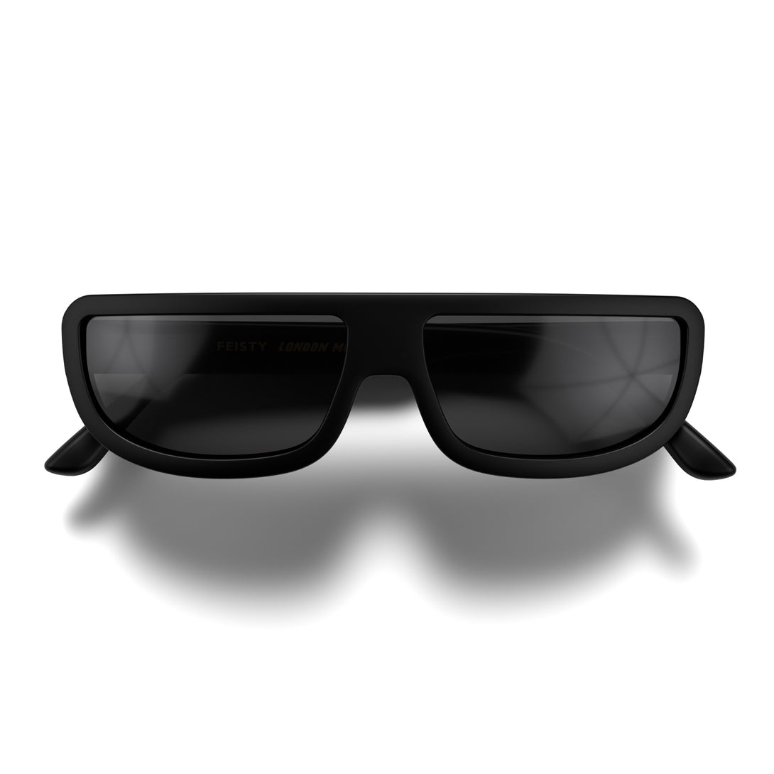 Front - Feisty sunglasses in matt black featuring a utilitarian, straight top line frame and black UV400 lenses. The finishing touch to every outfit while protecting your eyes. 