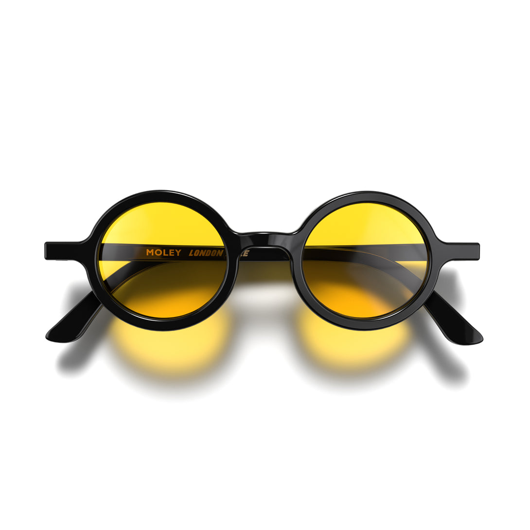Front - Moly sunglasses gloss black  featuring an eccentrically round frame and yellow UV400 lenses. The perfect accessory.